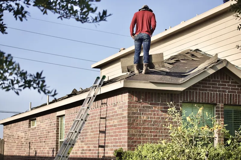 Professional roofer working on a residential roof in The Villages at Queen Creek